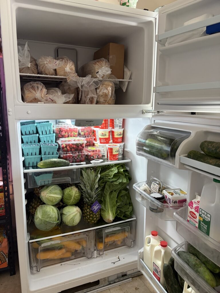 An open refrigerator full of perishable food